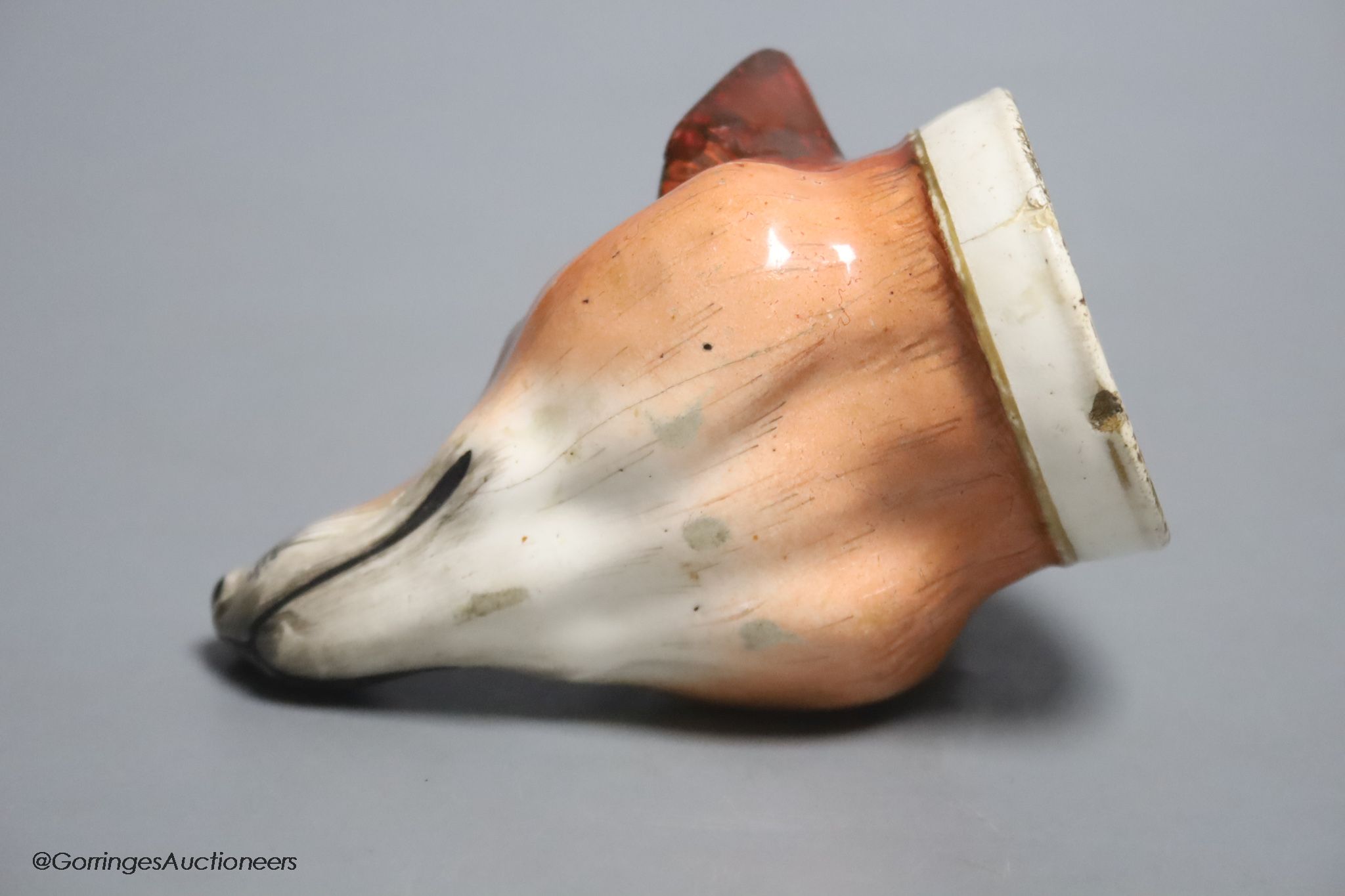 An early 19th century English porcelain 'Tally Ho' fox head stirrup cup, length 11cm